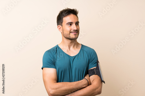 Handsome sport man over isolated background smiling a lot