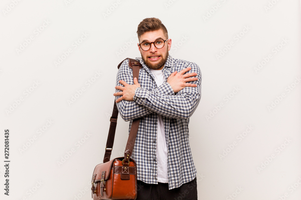 Young modern business man going cold due to low temperature or a sickness. Young modern business man going cold due to low temperature or a sickness.
