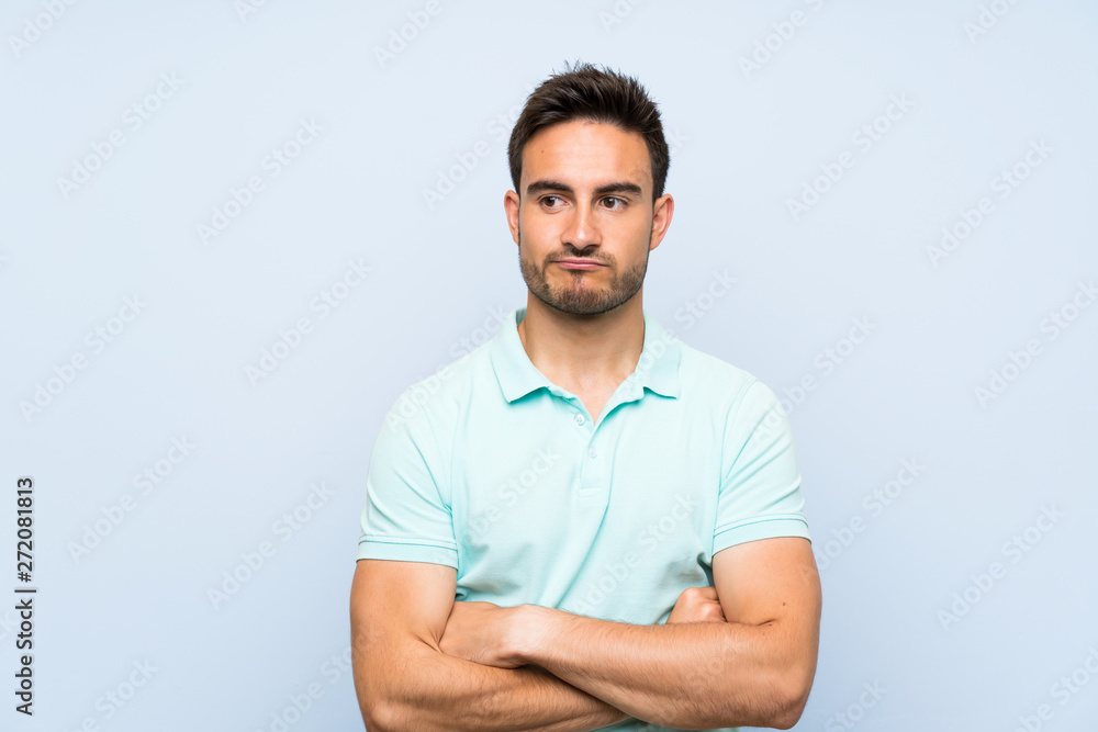 Handsome young man over isolated background with confuse face expression Handsome young man over isolated background with confuse face expression