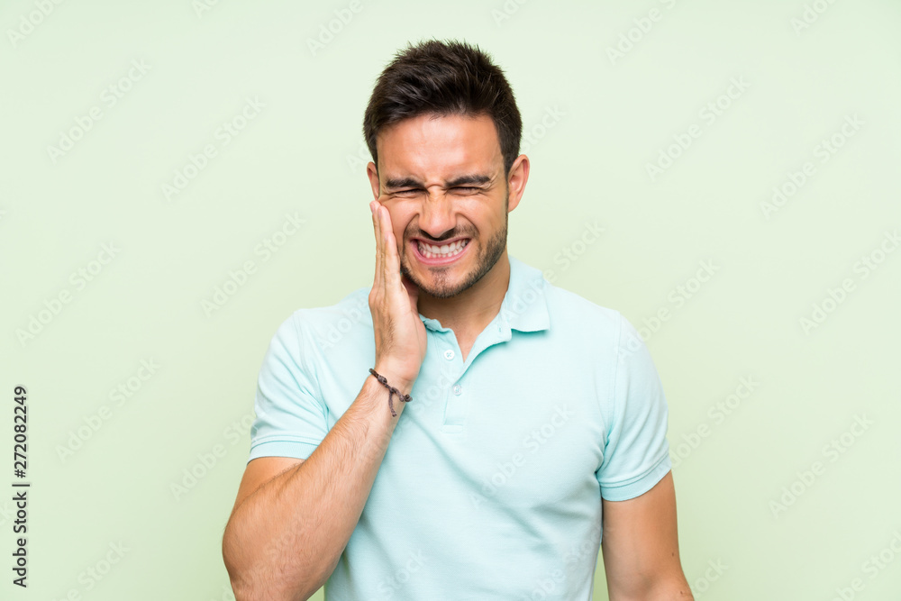 Handsome young man over isolated background with toothache Handsome young man over isolated background with toothache