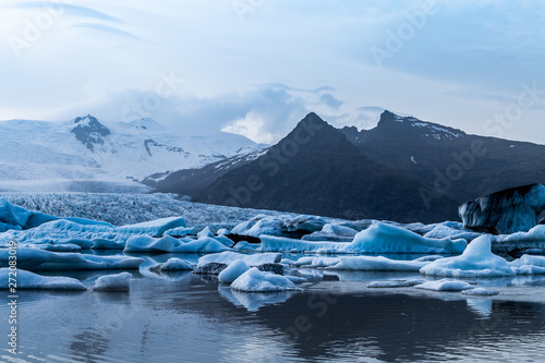 Glacier lake with icebergs with mountain and glacier in the background in Fjallsárlón, Iceland