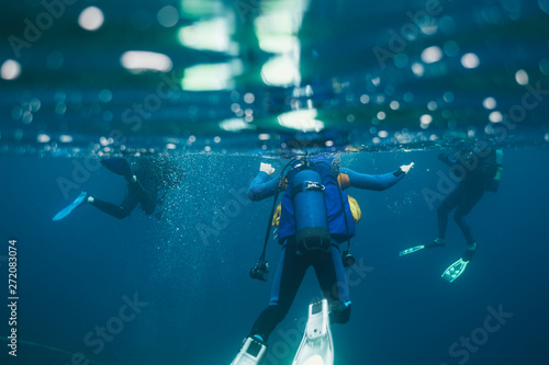 Divers underwater. Scuba divers preparing for go deep down © yossarian6