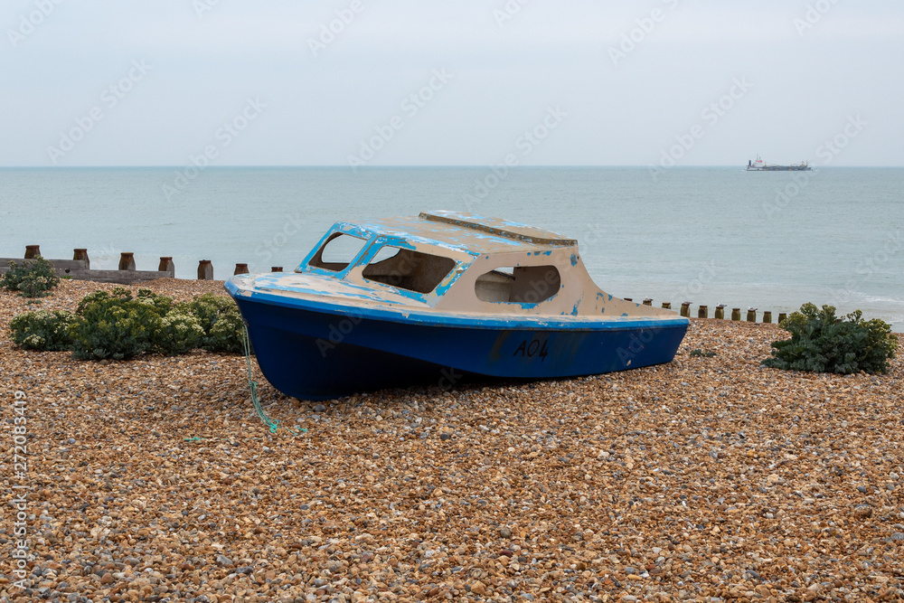 Abandoned Wooden Boat On A Pebble Beach Abandoned Wooden Boat On A Pebble Beach