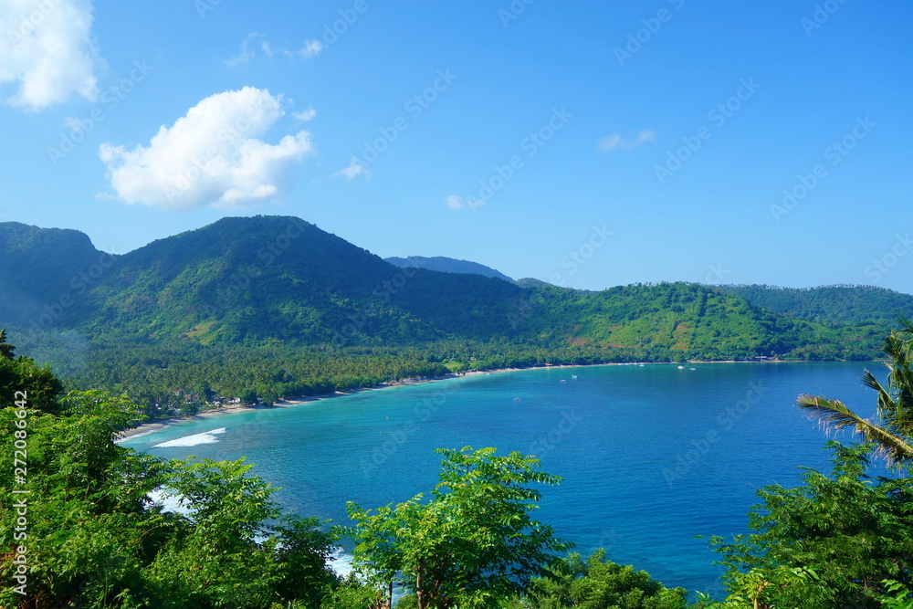 Beautiful landscape of Pantai Nipah, Lombok island scenic travel destination beach with crystal blue waters and coconut trees - near Bali, Indonesia