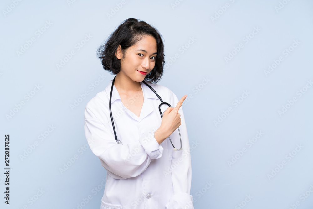 Doctor Asian woman pointing to the side to present a product Doctor Asian woman pointing to the side to present a product