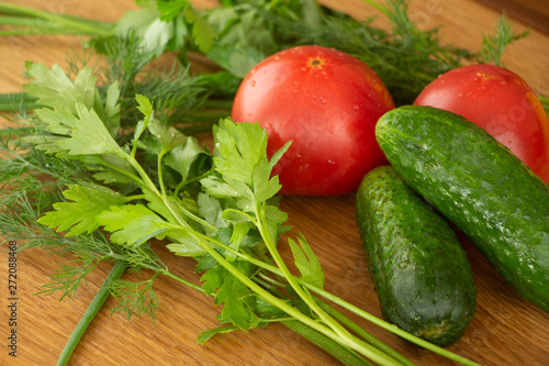 Summer vegetables for salad, tomatoes, cucumbers and herbs