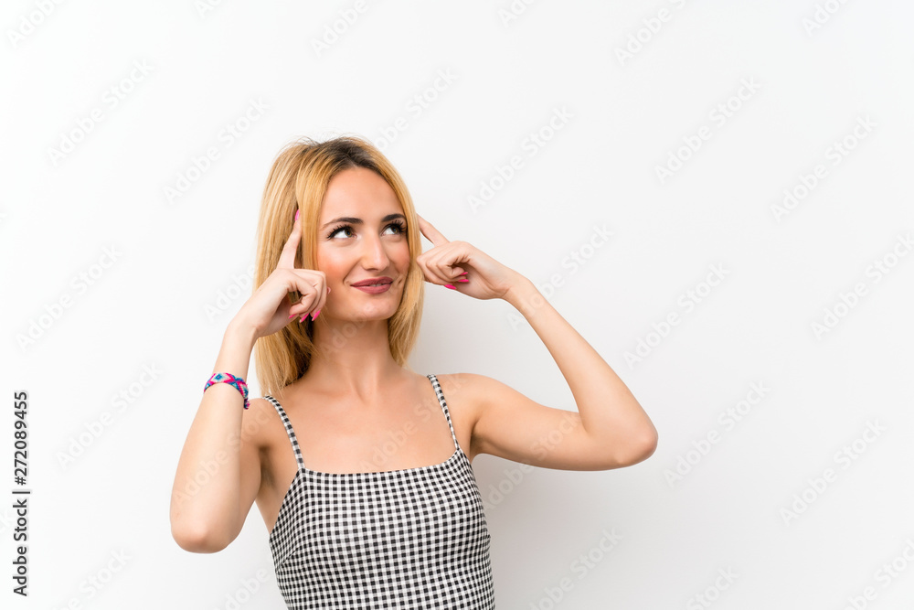 Young blonde woman over isolated white having doubts and thinking Young blonde woman over isolated white having doubts and thinking