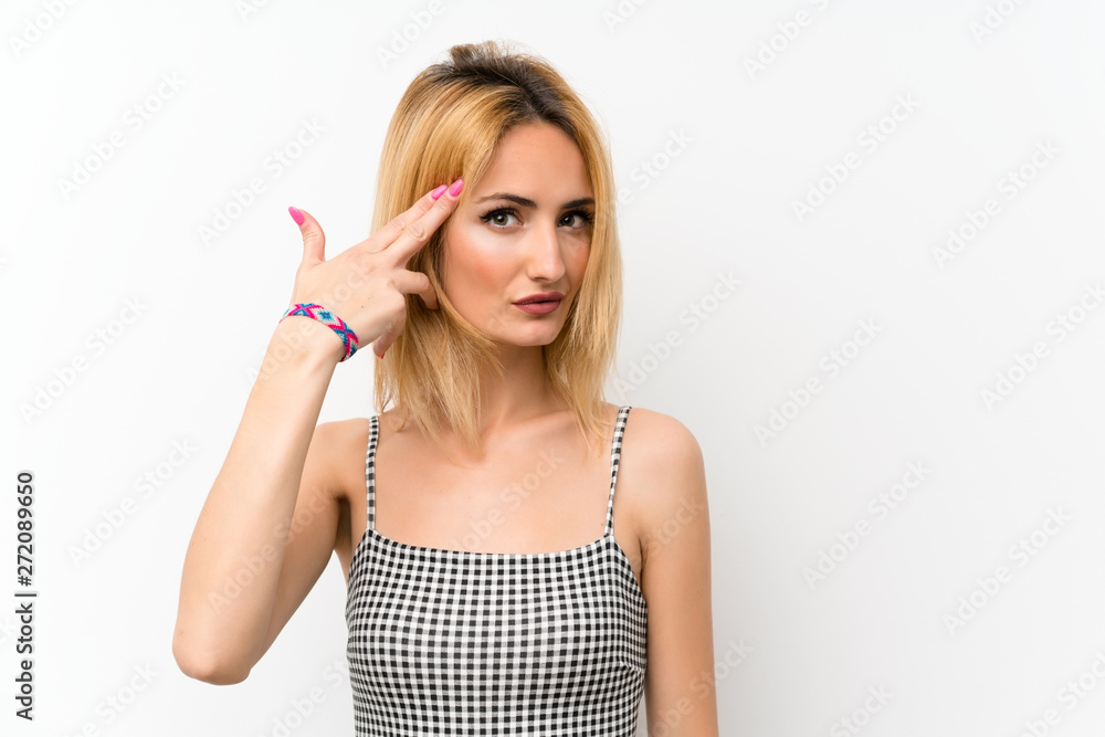 Young blonde woman over isolated white with problems making suicide gesture Young blonde woman over isolated white with problems making suicide gesture