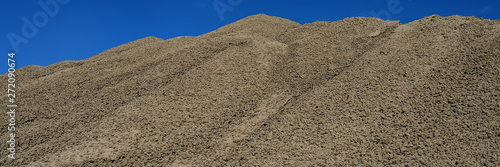 clinker surface in a raw material warehouse and blue sky, cement production.
