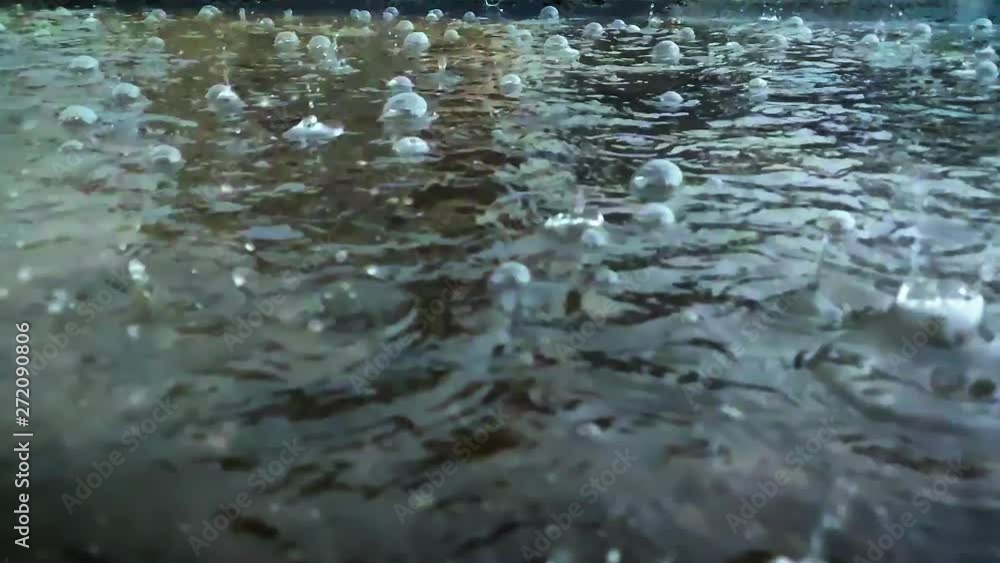 Heavy Rain On Water Surface, Slow Motion. Raining season. water droplet falling and hit on ground Heavy Rain On Water Surface, Slow Motion. Raining season. water droplet falling and hit on ground