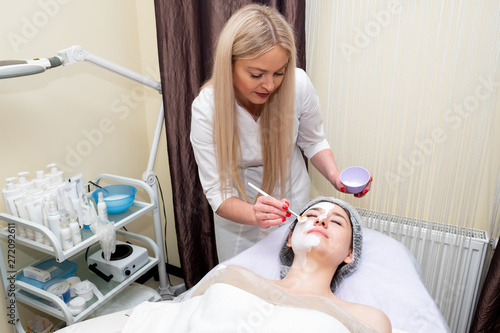 young woman in spa apply facial procedure