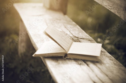 Obraz na plátně A moment from the gray past about a forgotten old book of stories lying on an old cracked wooden bench