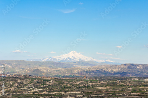 View of the Mount Erciyes ( Turkish: Erciyes Dagi ) from Uchisar Castle in Cappadocia Region. Also known as Argaeus, is a volcano in Turkey. photo