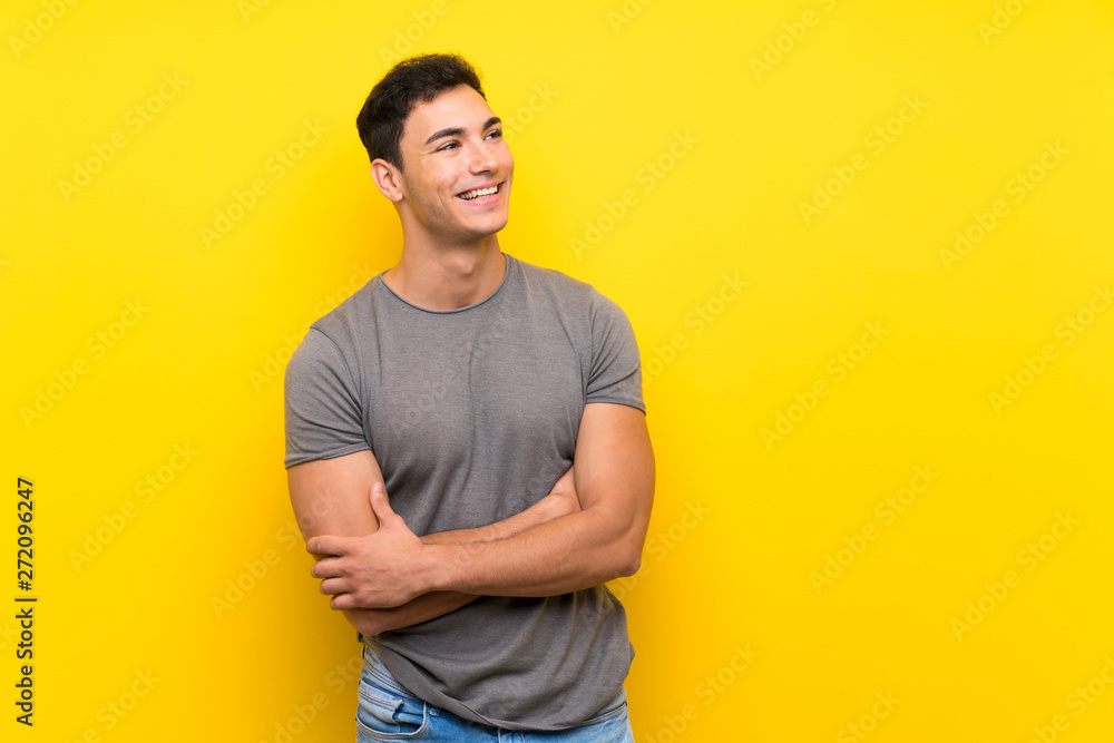 Handsome man over isolated yellow wall happy and smiling Handsome man over isolated yellow wall happy and smiling