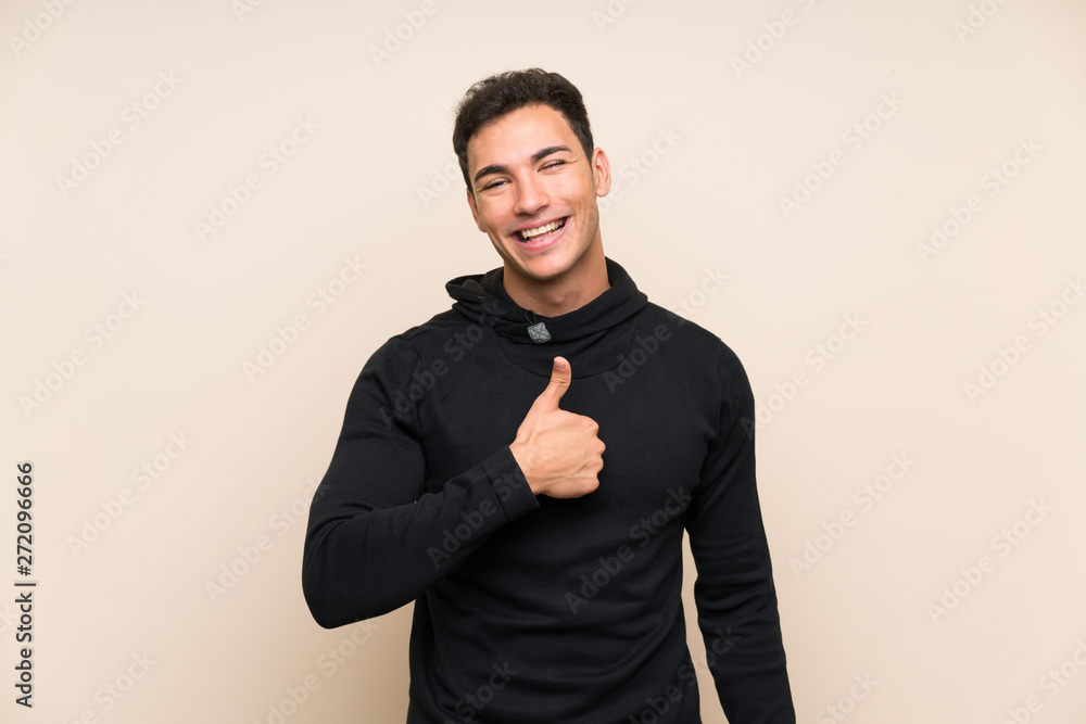 Handsome man over isolated background giving a thumbs up gesture Handsome man over isolated background giving a thumbs up gesture