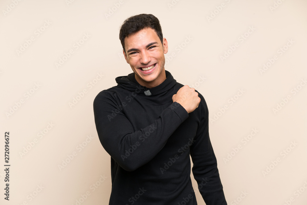 Handsome man over isolated background celebrating a victory Handsome man over isolated background celebrating a victory