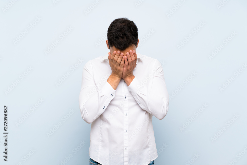 Handsome man over blue wall with tired and sick expression Handsome man over blue wall with tired and sick expression