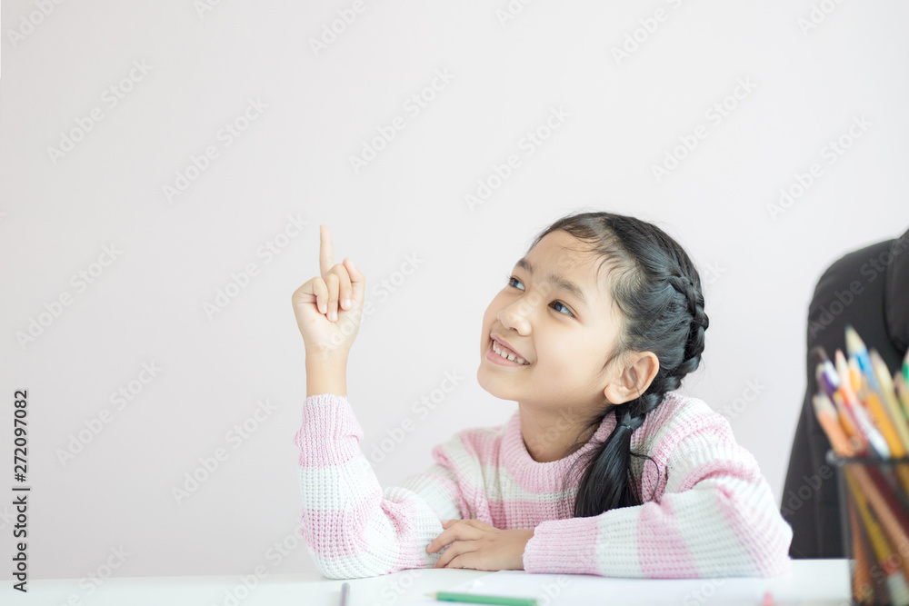 Portrait little Asian girl pointing finger and smile with happiness with copy space select focus shallow depth of field Portrait little Asian girl pointing finger and smile with happiness with copy space select focus shallow depth of field