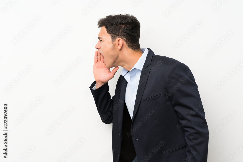Handsome man over isolated white wall shouting with mouth wide open Handsome man over isolated white wall shouting with mouth wide open