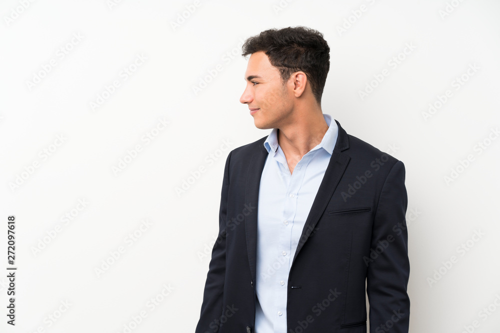 Handsome man over isolated white wall looking to the side Handsome man over isolated white wall looking to the side
