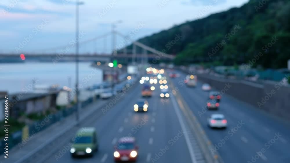 Downtown car traffic during the day time commuting to work and school. Soft focus of city traffic moving through the street. Blurred view of vehicle rush hour traffic. Downtown car traffic during the day time commuting to work and school. Soft focus of city traffic moving through the street. Blurred view of vehicle rush hour traffic.