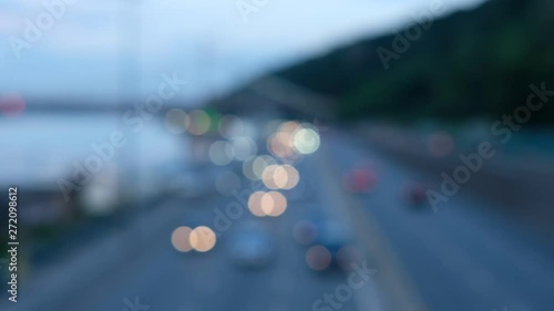 Downtown car traffic during the day time commuting to work and school. Soft focus of city traffic moving through the street. Blurred view of vehicle rush hour traffic.