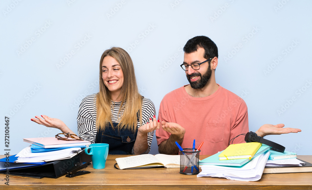 Students with many books holding copyspace with two hands Students with many books holding copyspace with two hands