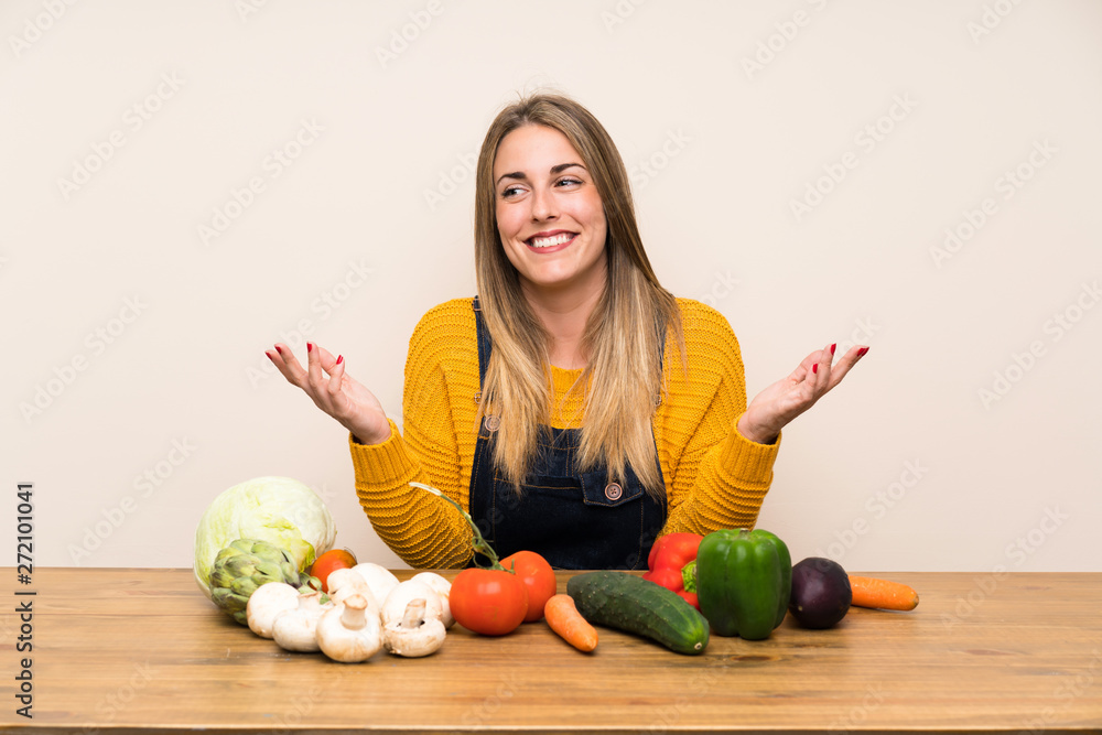 Fototapeta premium Woman with lots of vegetables laughing