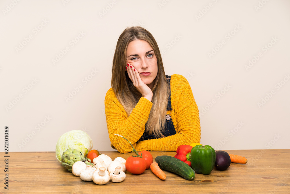 Fototapeta premium Woman with lots of vegetables unhappy and frustrated
