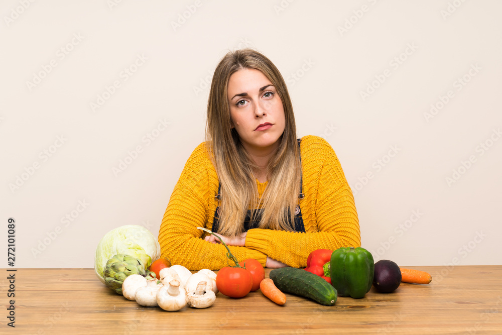 Fototapeta premium Woman with lots of vegetables sad