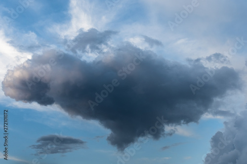 Dark cloud in a reminiscent of heart on the background of a bright evening sky.