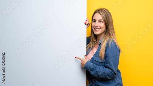 Happy Young woman holding an empty placard