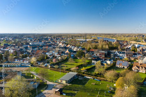 Obraz na plátně Aerial view of Baasrode, a small flemish town on the shore of the Scheldt river