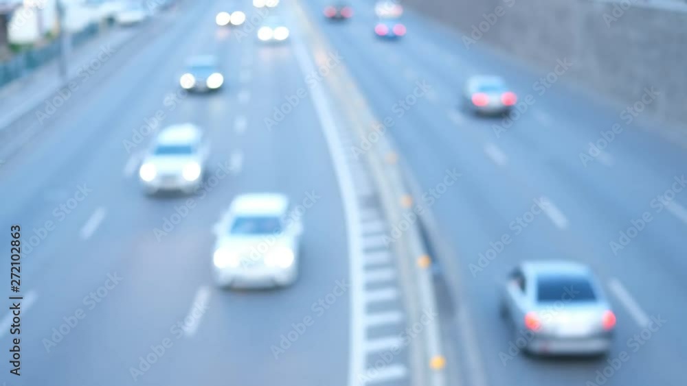 Downtown car traffic during the day time commuting to work and school. Soft focus of city traffic moving through the street. Blurred view of vehicle rush hour traffic. Downtown car traffic during the day time commuting to work and school. Soft focus of city traffic moving through the street. Blurred view of vehicle rush hour traffic.