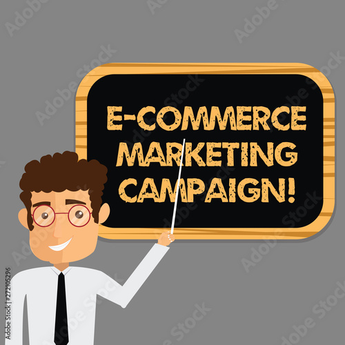 Text sign showing E Commerce Marketing Campaign. Conceptual photo driving awareness of the brand though online Man Standing Holding Stick Pointing to Wall Mounted Blank Color Board