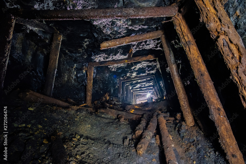 Abandoned coal mine with rotten collapsed wooden miner stands. Old derelict coal development