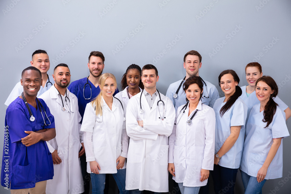 Portrait Of Medial Team Against Grey Background Portrait Of Medial Team Against Grey Background