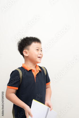 Happy little boy with book isolated on white background