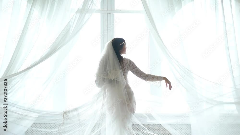 Charming Brunette Bride In White Dress Posing Near The Window Charming Brunette Bride In White Dress Posing Near The Window