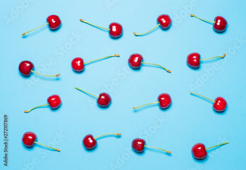 texture of red sweet cherry on a blue background