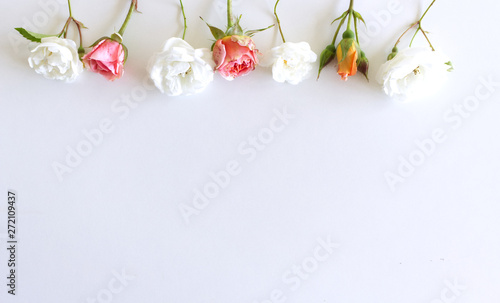 Floral pattern made of pink and white roses, green leaves, branches on white background. Flat lay, top view. Valentines background. Floral pattern. Pattern of flowers. Flowers pattern texture.