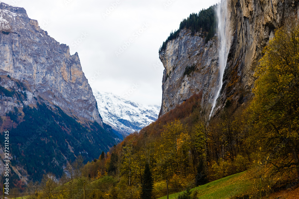 Beautiful autumn time at village of Lauterbrunnen in Swiss alps, gateway to famous Jungfrau. Set in a valley featuring rocky cliffs and the roaring, 300m-Â­high Staubbach Falls