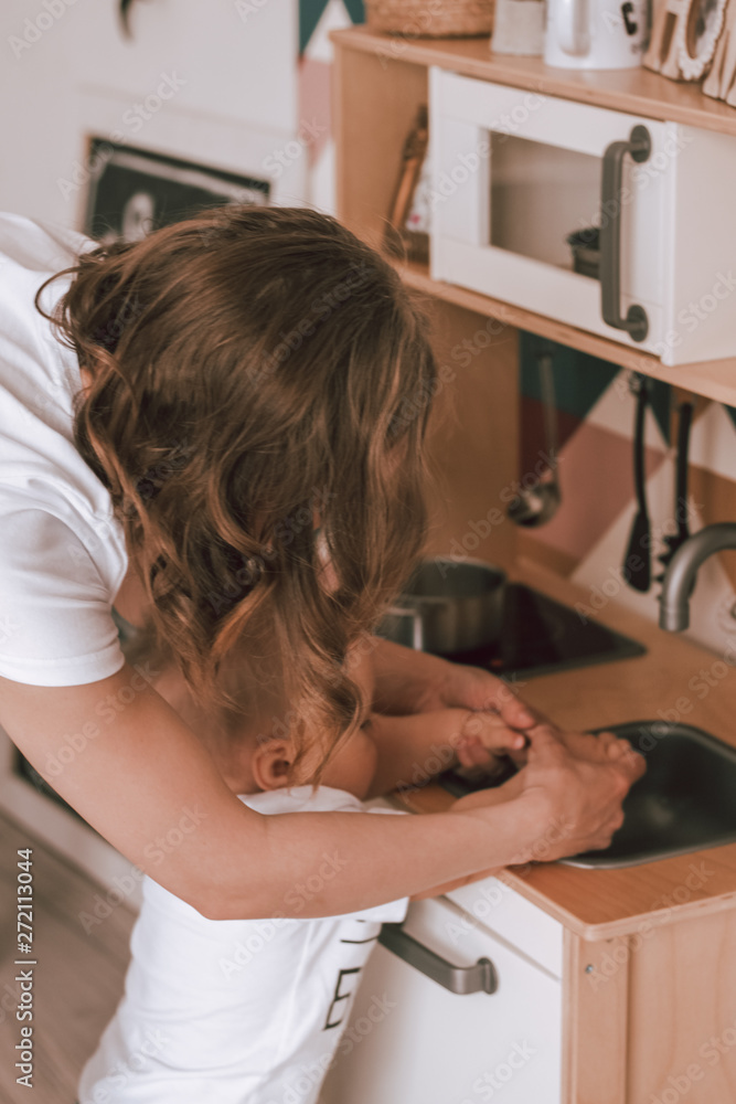 Mother and son play at the table indoors children's room Mother and son play at the table indoors children's room
