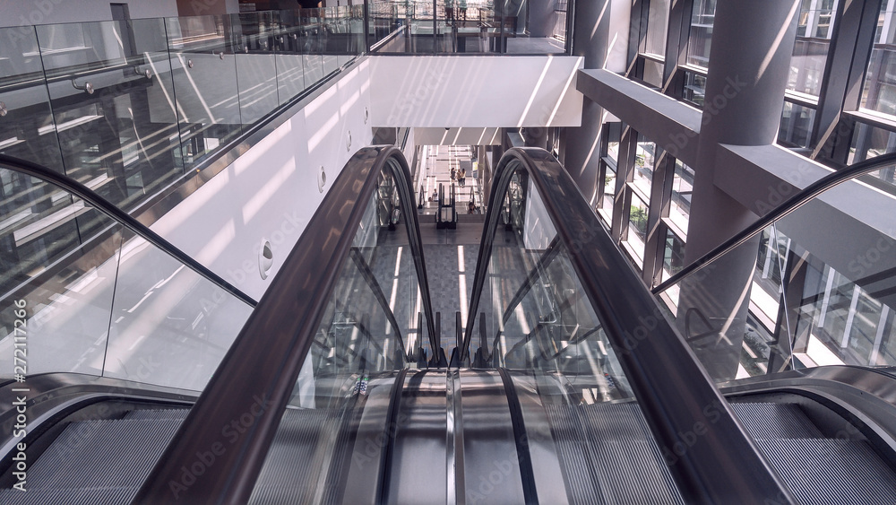 Fototapeta premium Moving escalator in interior of office building