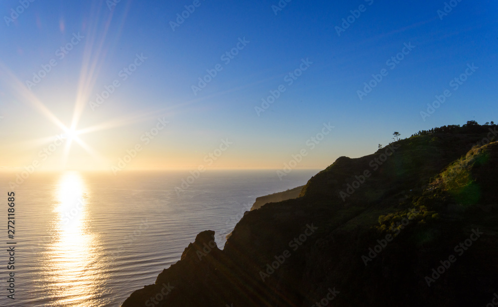 Wide angle shot: Traveling on the beautiful island Madeira: View of beautiful mountains and ocean on southern coast with evening sunset light, Portugal, Europe.