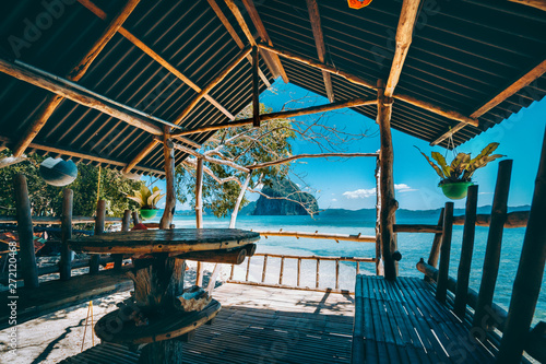Tropical getaway remote panorama of impressive Pinagbuyutan island from the native wood and bamboo terrace, beauty of Philippines island © Igor Tichonow