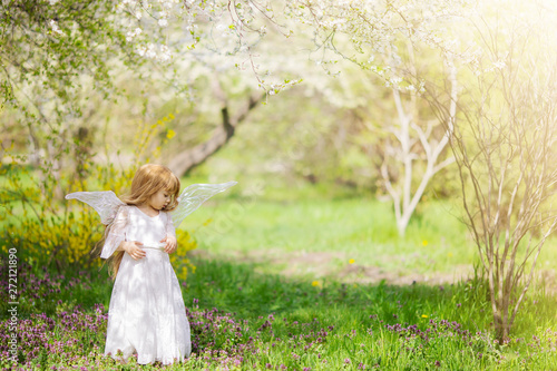 Fairy tale consept. Little girl wearing beautiful princess dress with fairy wings, spring day