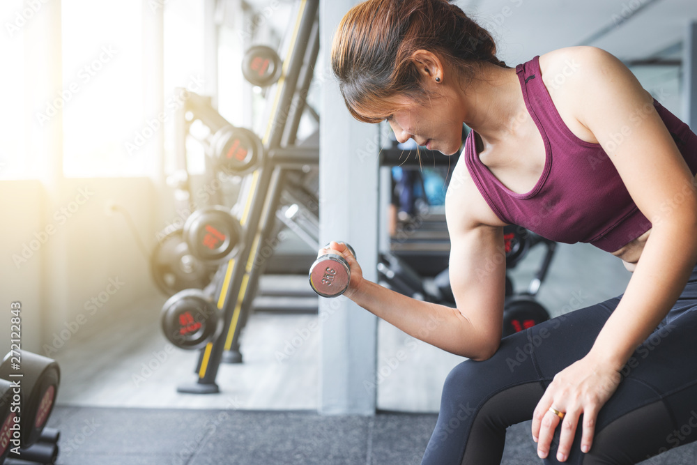 Fitness Asian girl lifting dumbbell at gym. Fitness Asian girl lifting dumbbell at gym.