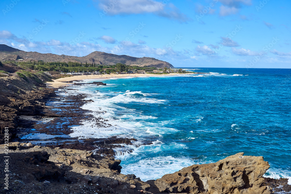 A view of the hawaiian beach and ocean during daylight. A view of the hawaiian beach and ocean during daylight.
