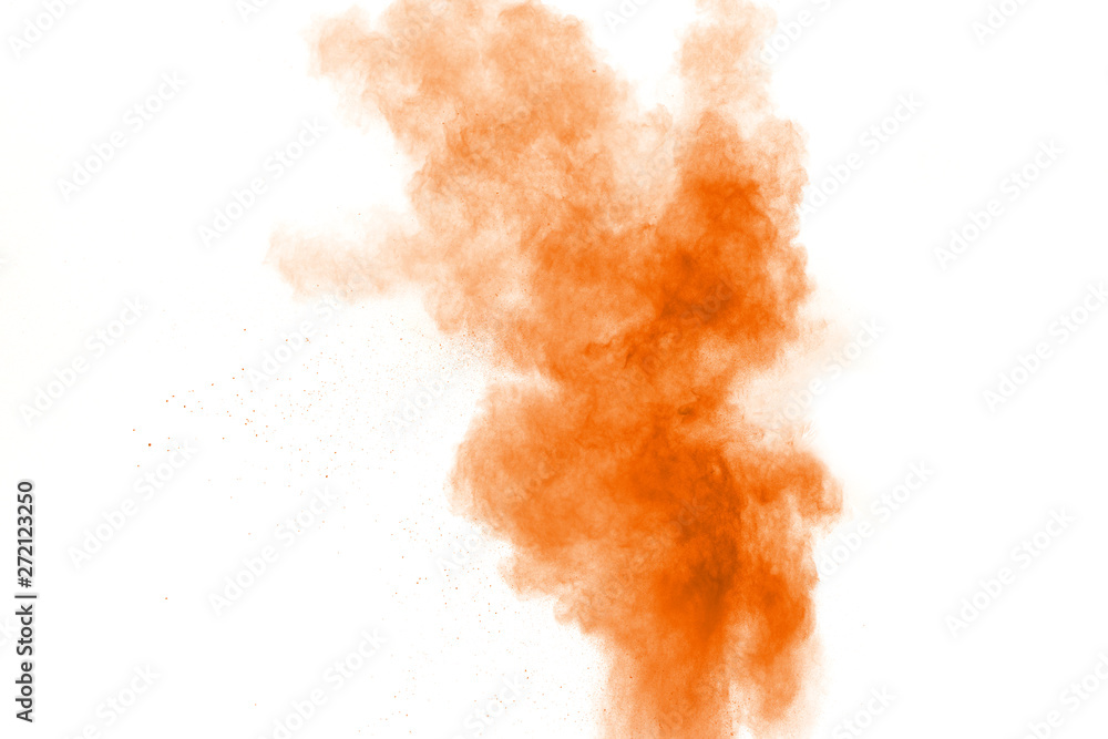 Orange color powder explosion cloud on white background. Orange dust particle splash.